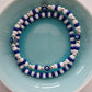A pair of blue and white bead bracelets one of them features evil eye charm beads