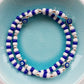 2 Blue and white bead bracelets one features evil eye charm beads