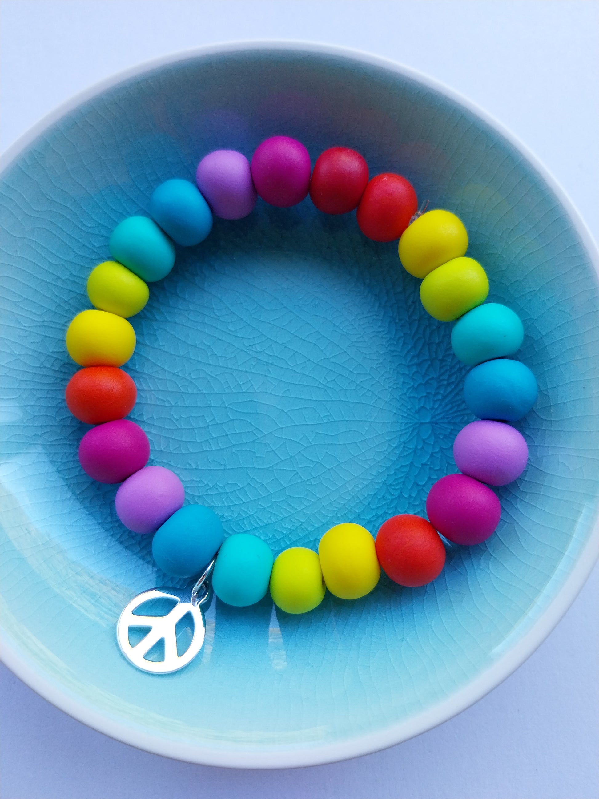 Multi-coloured clay bead bracelet with cute peace charm