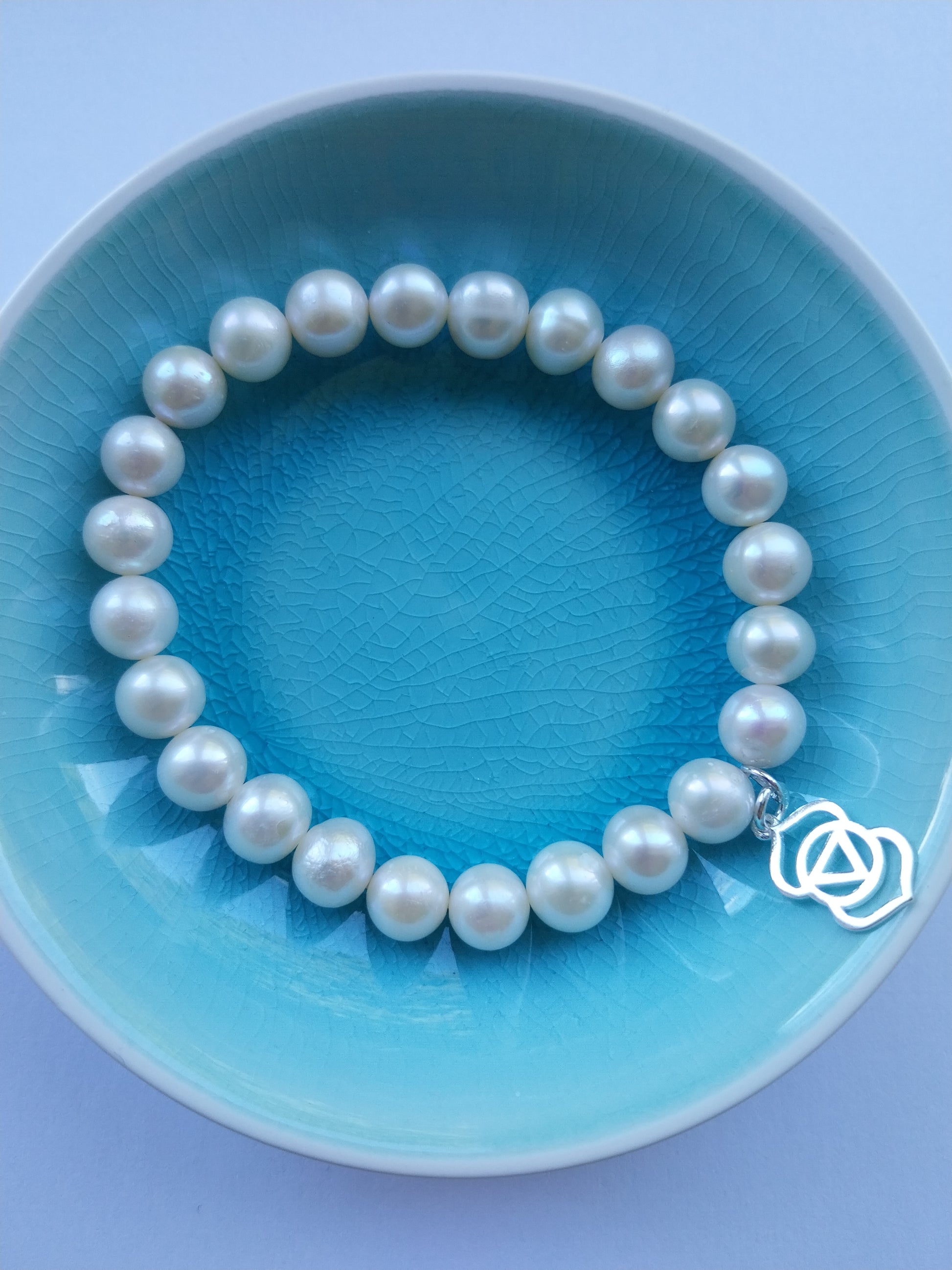 Pearl bracelet featuring third eye chakra sterling silver charm