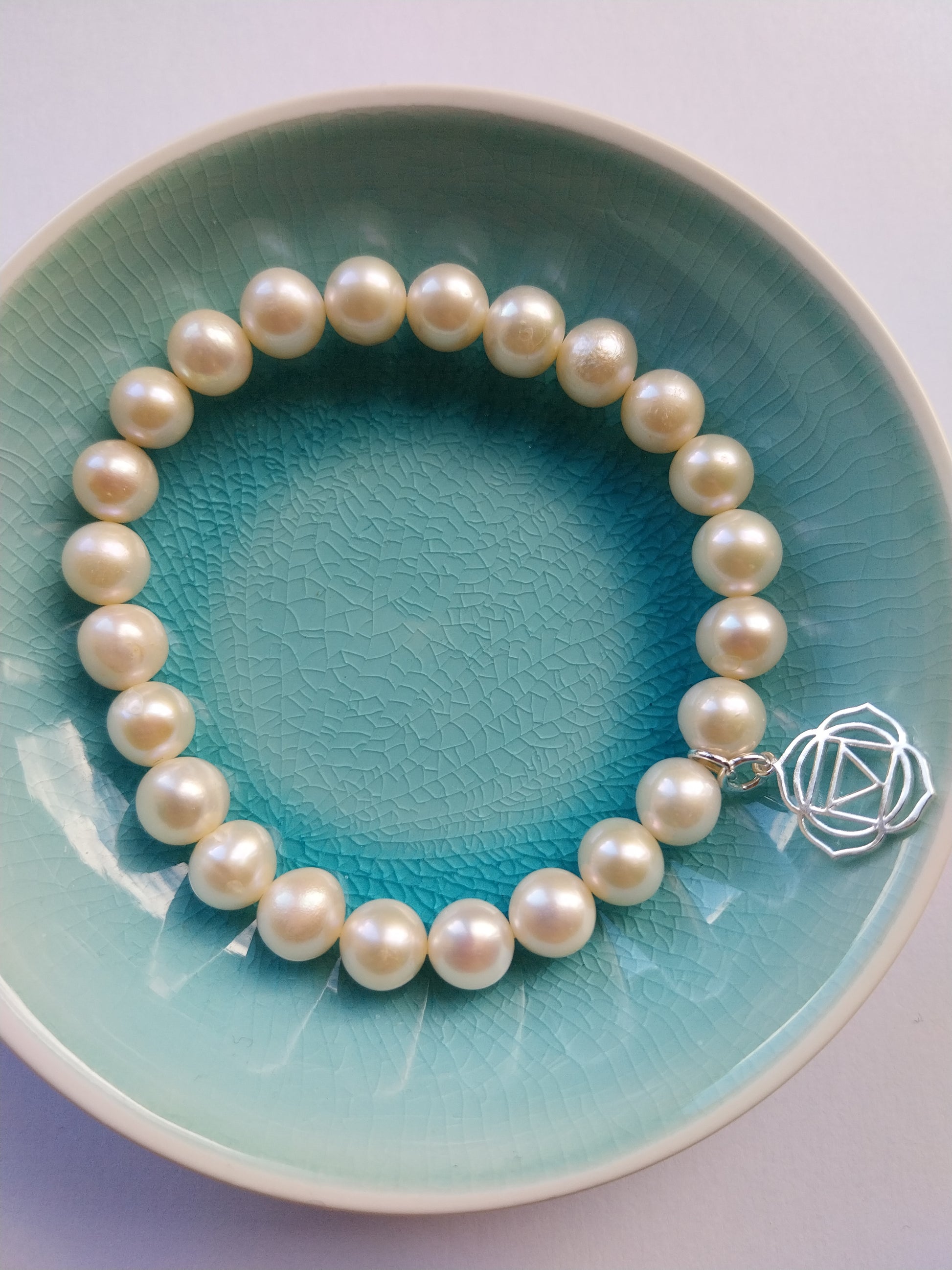 Pearl bracelet with root chakra sterling silver charm