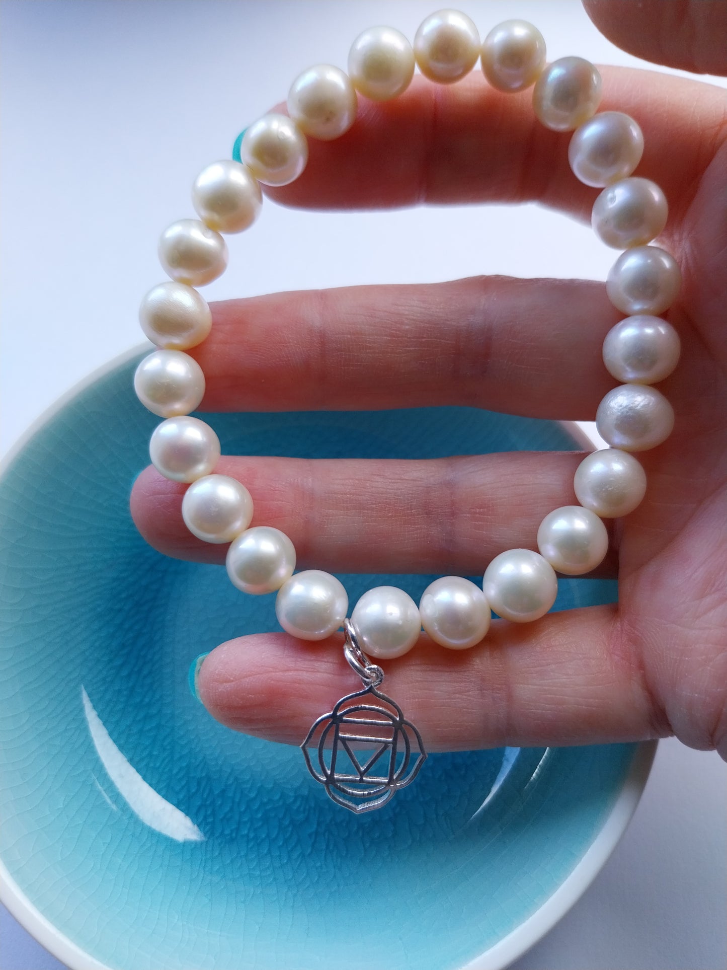 Pearl bracelet with sacral chakra silver charm