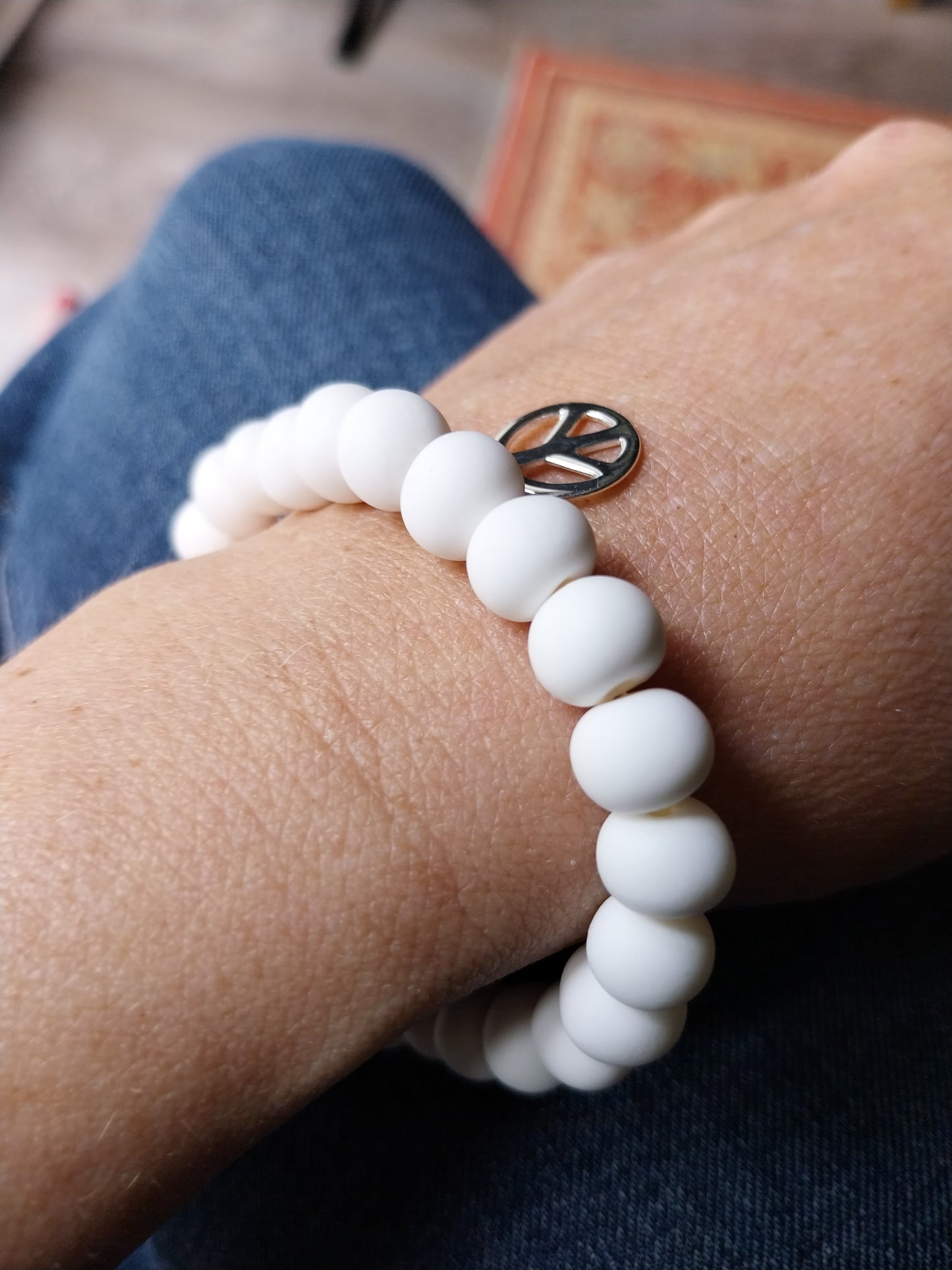 White clay bead bracelet with silver peace charm