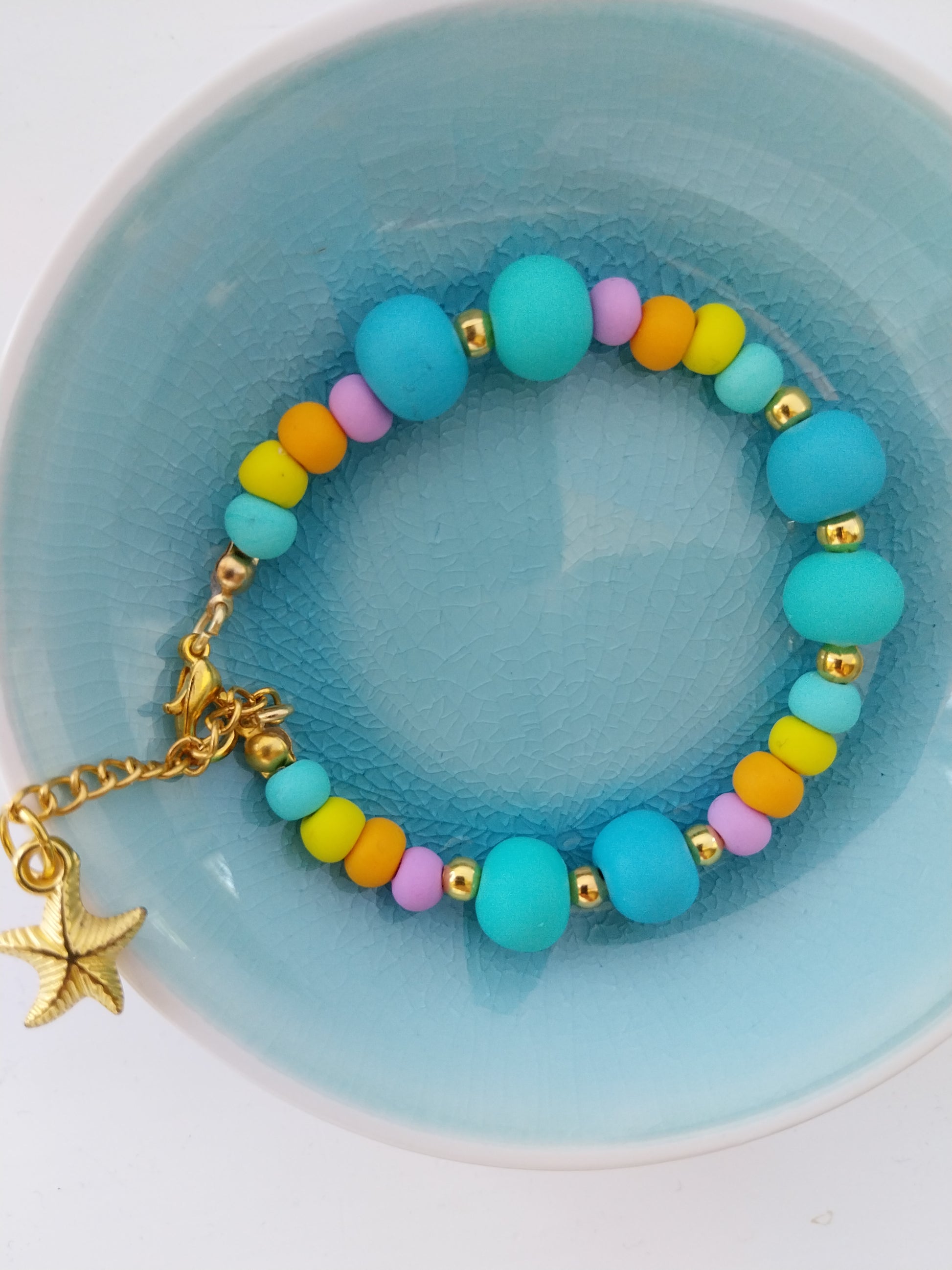 Pastel coloured polymer clay bead bracelet with gold plated starfish charm