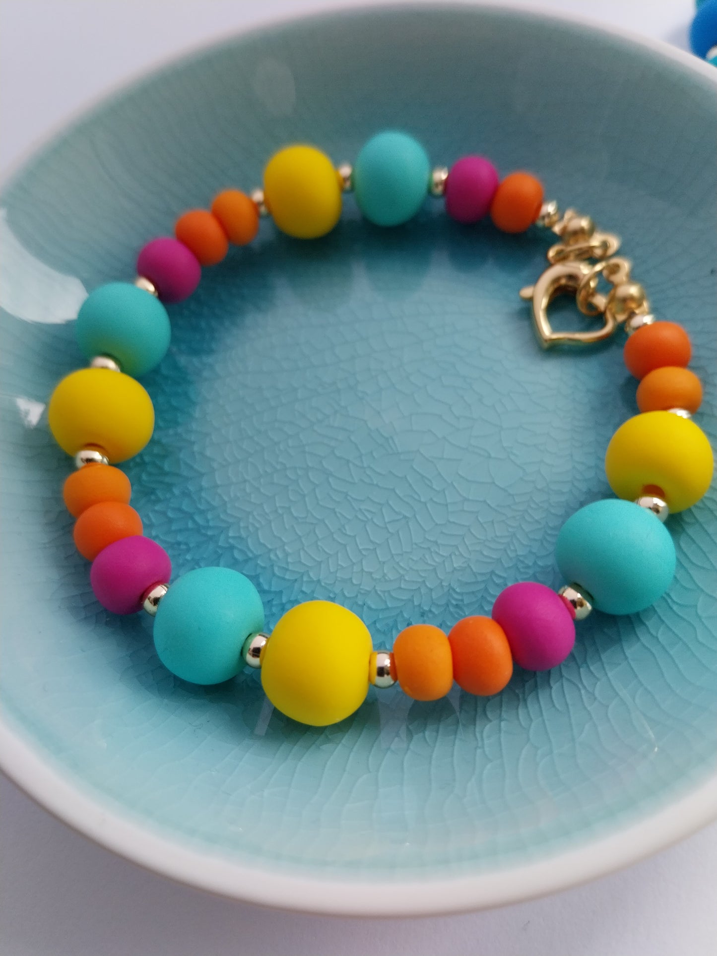 Multi coloured polymer clay bead bracelet with gold plated heart clasp