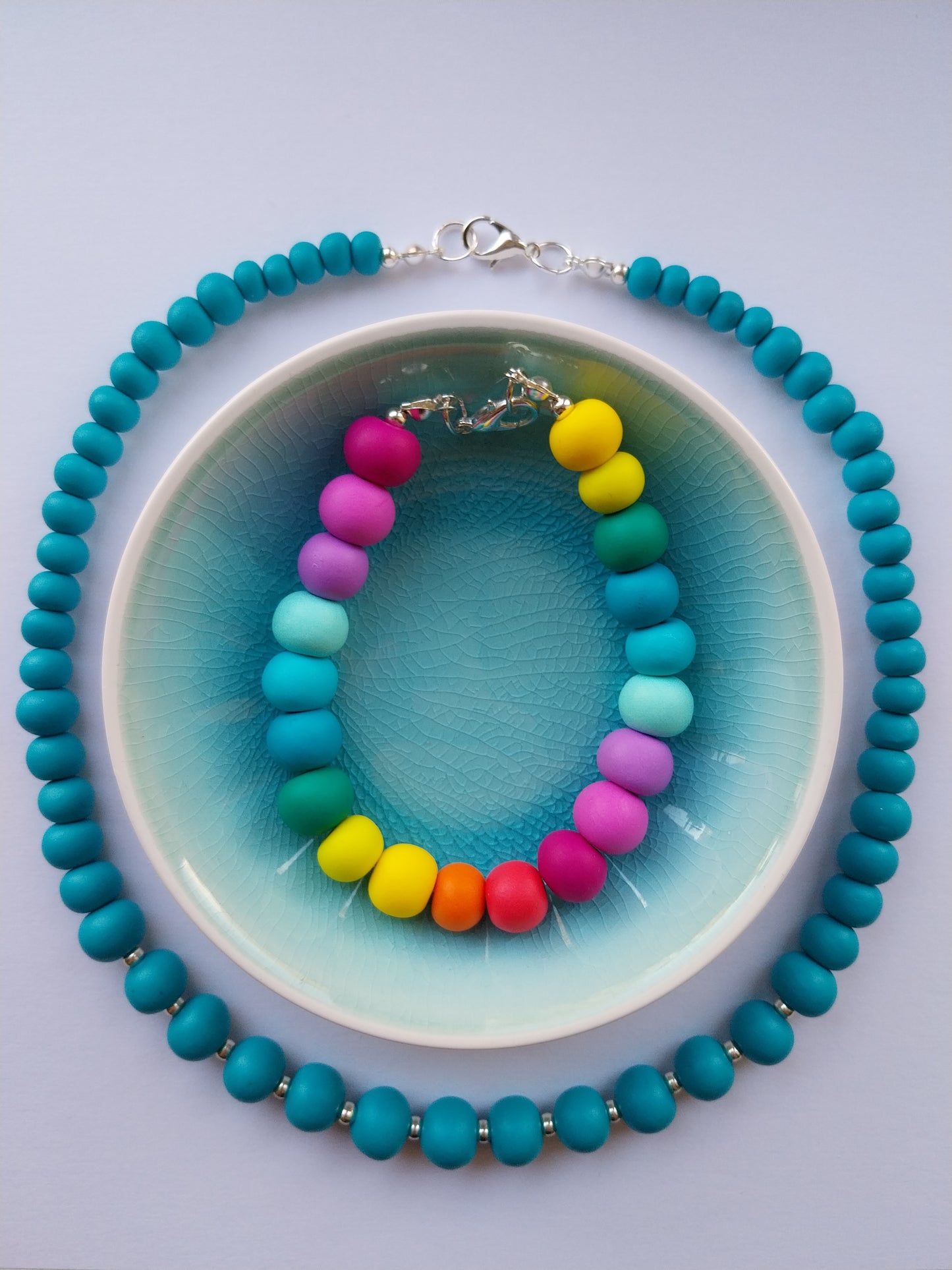 Multi-coloured clay bead bracelet featuring silver plated clasp