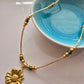 Gold Flower Pendant Necklace – Handmade Boho Jewellery with Green Glass Beads