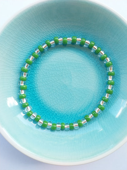 Elasticated bracelet with green and crystal glass beads
