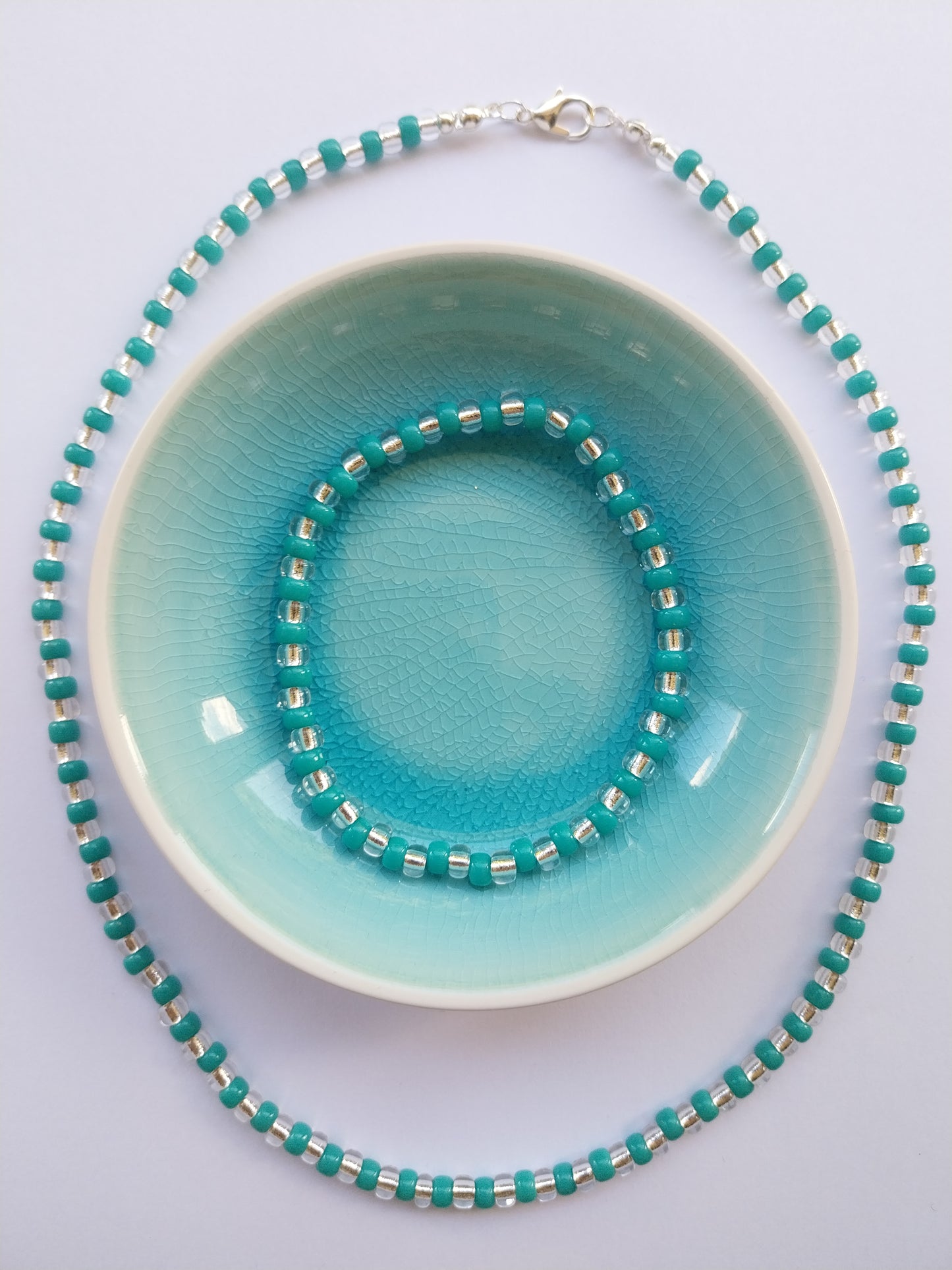 Glass bead necklace in teal and crystal with matching stretchy bracelet