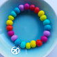 Multi-coloured clay bead bracelet with cute peace charm