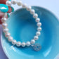 Pearl bracelet with sterling silver heart chakra charm