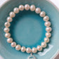 Pearl bracelet with throat chakra sterling silver charm
