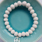 White clay bead bracelet with sterling silver peace charm