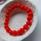 Ceramic unisex bead bracelet in orange red