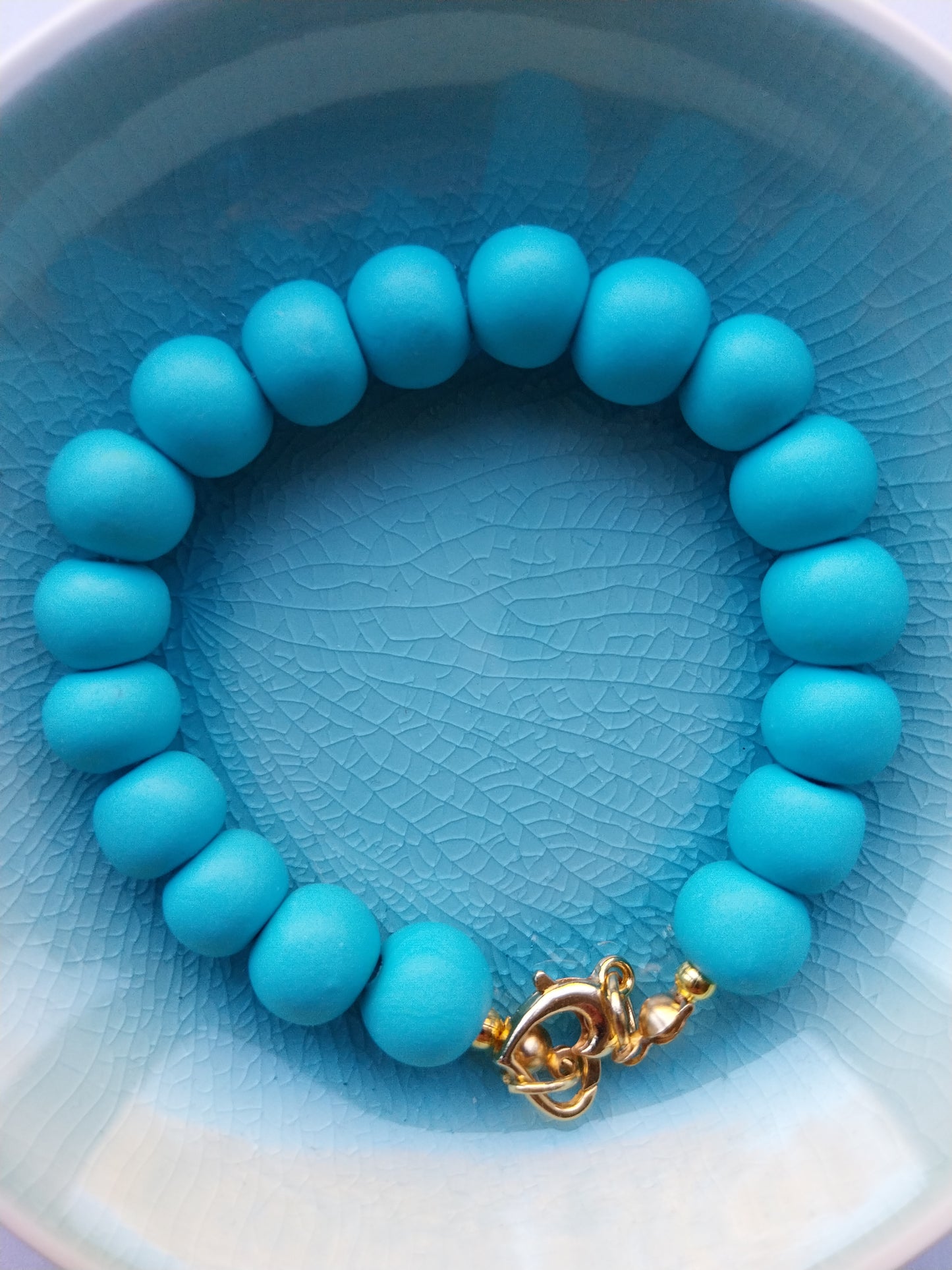 Turquoise polymer clay bead bracelet with gold plated heart shaped clasp