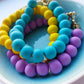 Colourful clay bead bracelets with gold plated heart clasp